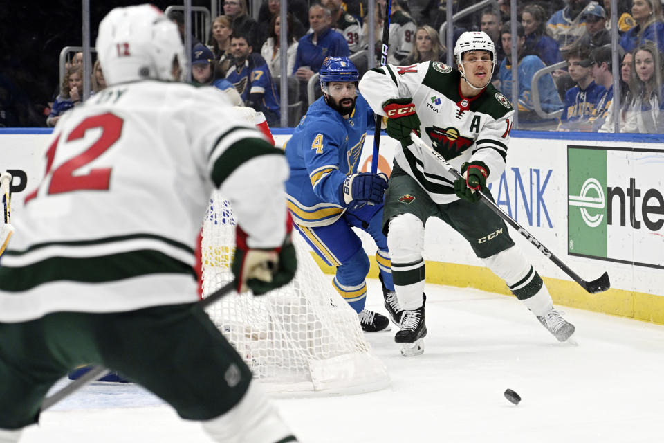 Minnesota Wild center Joel Eriksson Ek (14) passes the puck against the St. Louis Blues during the first period of an NHL hockey game on Saturday, March 2, 2024, in St. Louis. (AP Photo/Michael Thomas)