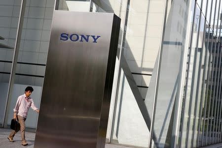 A man walks past the Sony brand logo outside the headquarters of Sony Corp in Tokyo, Japan, May 24, 2016. REUTERS/Thomas Peter