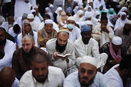 A Muslim pilgrim reads the Koran as he attends Friday prayers at the Grand mosque in the holy city of Mecca ahead of the annual haj pilgrimage in this October 11, 2013 file photo. REUTERS/Ibraheem Abu Mustafa/Files