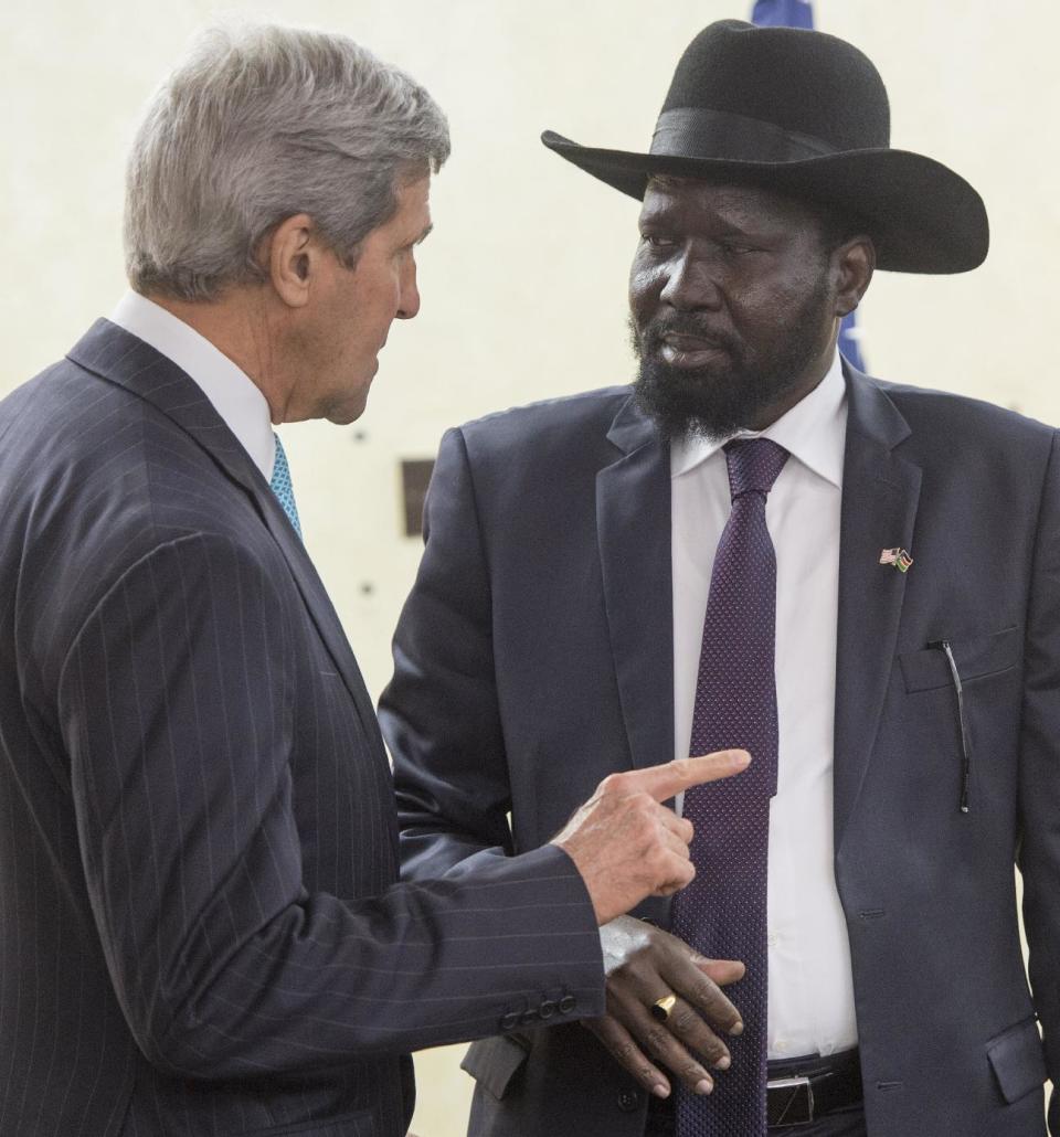 South Sudan's President Salva Kiir, right, listens to U.S. Secretary of State John Kerry as he greets Kerry at the President's Office in Juba, South Sudan, Friday, May 2, 2014. Kerry is urging South Sudan's warring government and rebel leaders to uphold a monthslong promise to embrace a cease-fire or risk the specter of genocide through continued ethnic killings. (AP Photo/Saul Loeb, Pool)