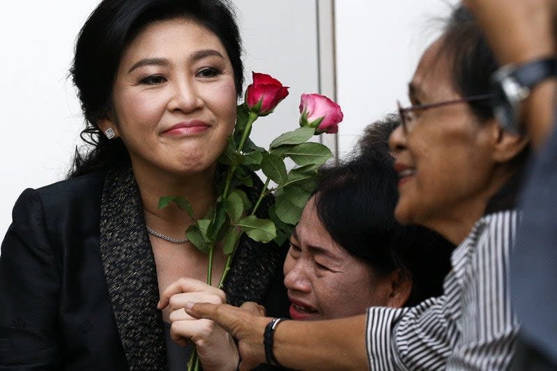 Ousted former Thai prime minister Yingluck Shinawatra greets supporters as she arrives at the Supreme Court in Bangkok - Athit Perawongmetha/Reuters