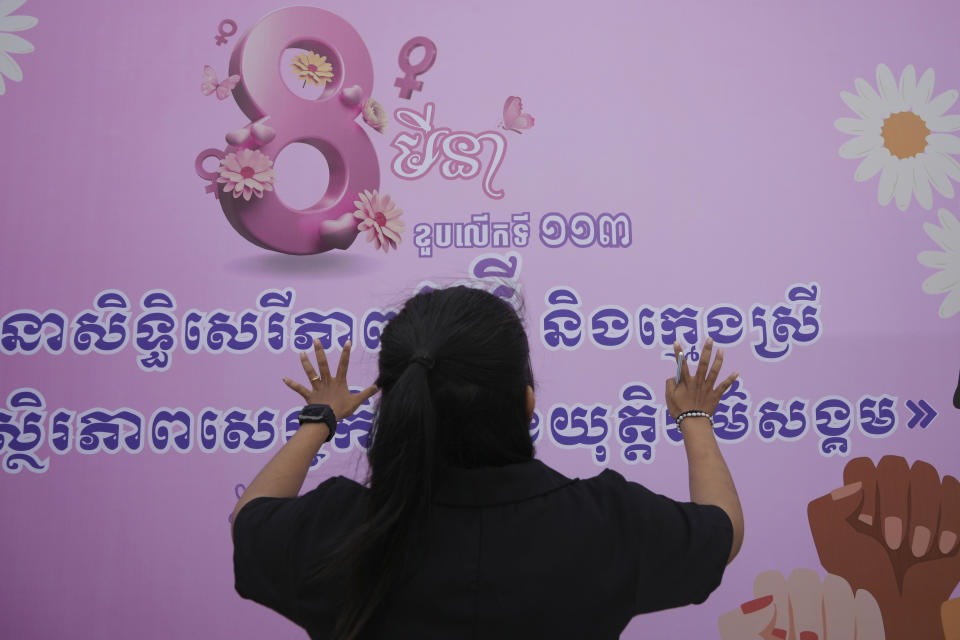 A Cambodian civil society organization member prepares a canvas during a celebration to mark the International Women's Day at Freedom Park in Phnom Penh Cambodia, Friday, March 8, 2024. The canvas reads "Guarantees the rights of women and girls for economic stability and social justice." (AP Photo/Heng Sinith)