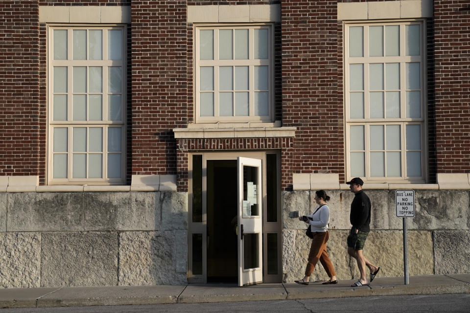 People walk toward a polling place on Election Day, Tuesday, Nov. 7, 2023, at Westwood Elementary School in Cincinnati. Polls are open in a few states for off-year elections that could give hints of voter sentiment ahead of next year's critical presidential contest. (AP Photo/Joshua A. Bickel)