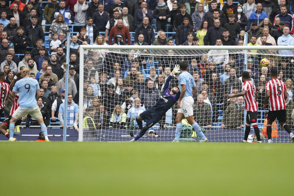 Manchester City's Phil Foden, unseen in the frame , scores his side's first goal during the English Premier League soccer match between Manchester City and Brentford, at the Etihad stadium in Manchester, England, Saturday, Nov.12, 2022. (AP Photo/Dave Thompson)