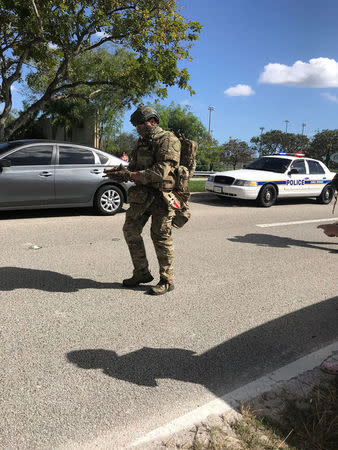 SWAT and police are seen in Coral Springs, Florida, U.S. February 14, 2018 in this image obtained from social media. CREDIT: TWITTER / @GRUMPYHAUS via REUTERS