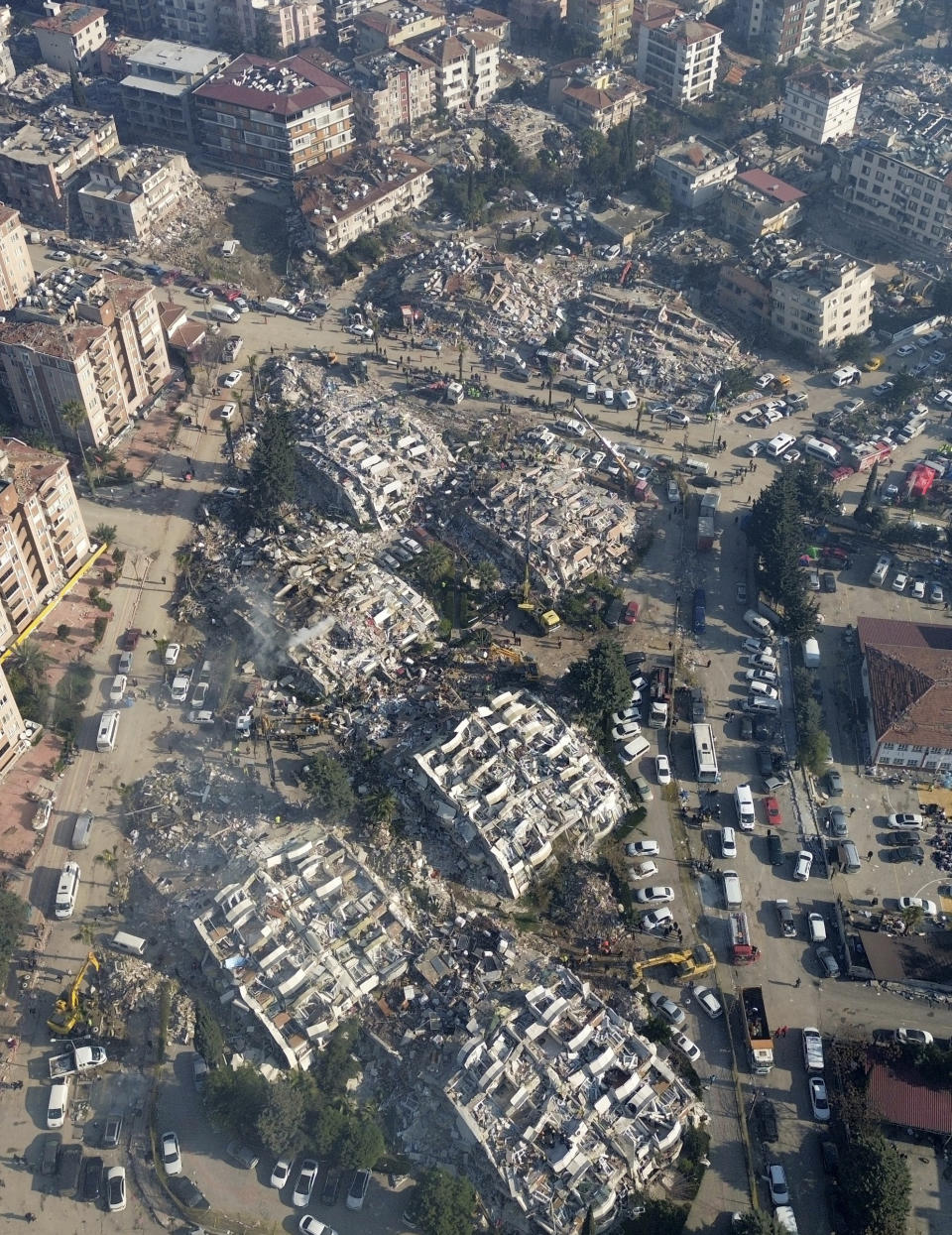 Aerial photo showing the destruction in Hatay city center, southern Turkey, Thursday, Feb. 9, 2023. Thousands who lost their homes in a catastrophic earthquake huddled around campfires and clamored for food and water in the bitter cold, three days after the temblor and series of aftershocks hit Turkey and Syria. (IHA via AP)