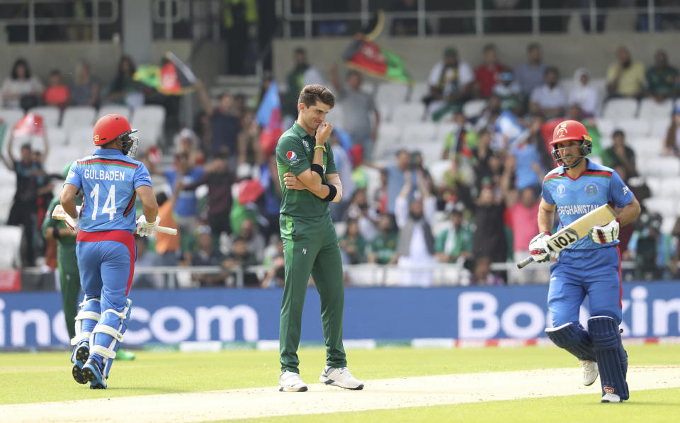 Pakistan's Shaheen Afridi, center, watches Afghanistan's captain Gulbadin Naib, left, and Afghanistan's Rahmat Shah take a run during the Cricket World Cup match between Pakistan and Afghanistan at Headingley in Leeds, England, Saturday, June 29, 2019. (AP Photo/Rui Vieira)