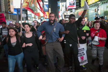 Protesters march through Times Square during a demonstration calling for social, economic and racial justice, in the Manhattan borough of New York City April 29, 2015. REUTERS/Andrew Kelly