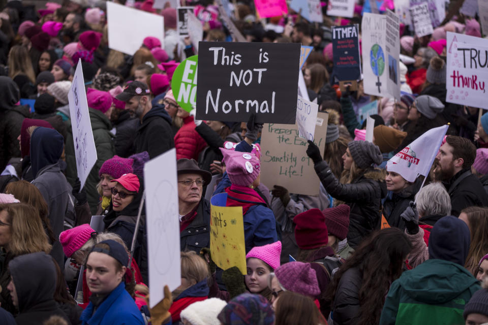 Demonstrators hold signs during the 2019 Women’s March on Jan. 19, 2019 in Washington. (Photo: Zach Gibson/Getty Images)