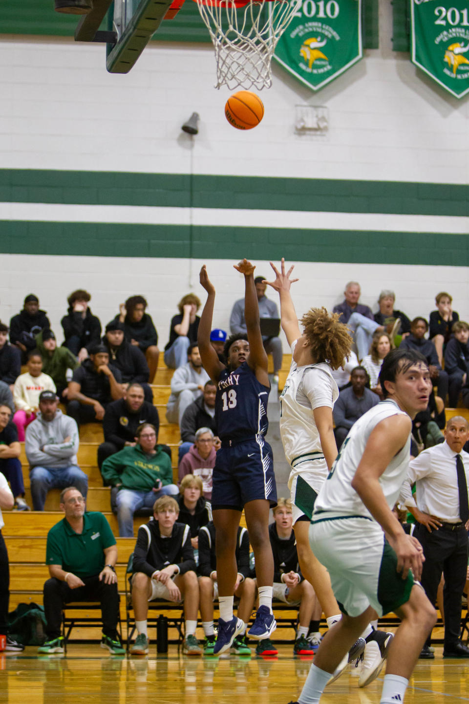 D'Andre Harrison (13) jumps to shoot the ball from the 3-point line at Sunnyslope High School gym.