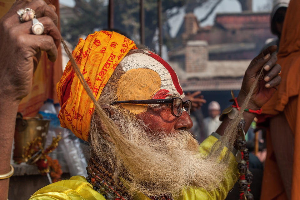 KATHMANDU, NEPAL - FEBRUARY 17:  A Shadu, or holy man, plays with his beard inside Pashupatinath temple during the celebration of the Maha Shivaratri festival on February 17, 2015 in Kathmandu, Nepal. 