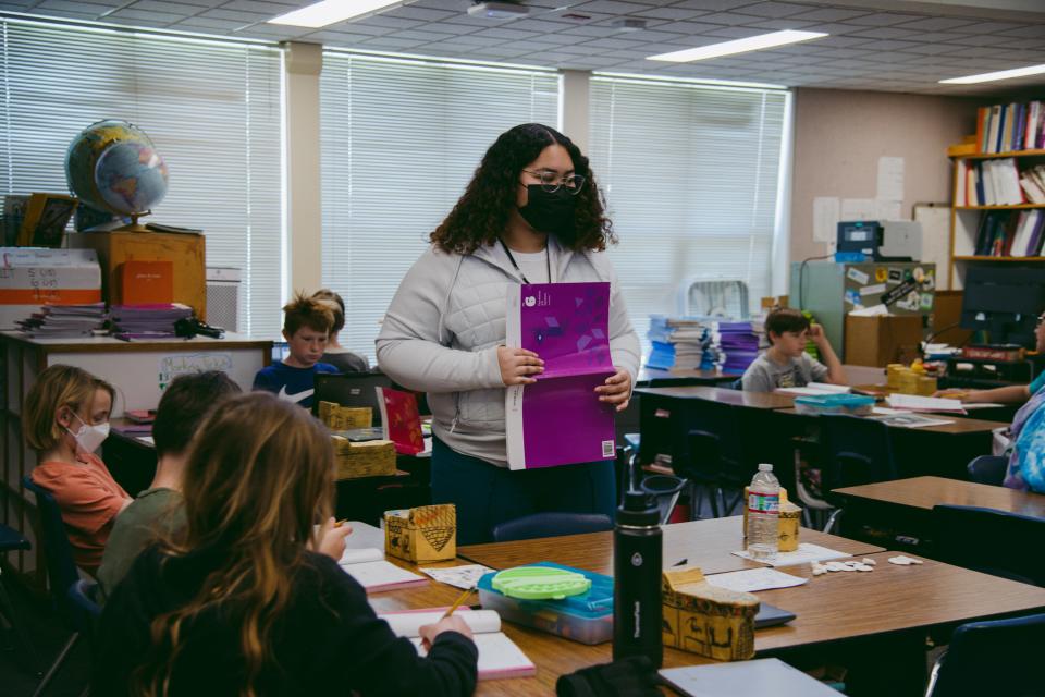 CollegeCorps member Markeia Warren helps a student with their coursework at Patwin Elementary School in Davis, Calif., March 3, 2023. Warren was drawn to the program’s K-12 education track to prepare her for a career as a school psychologist.
