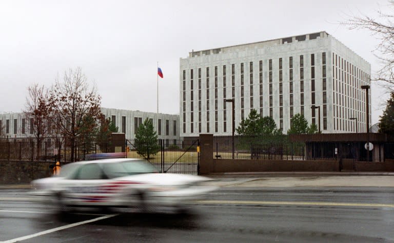 A police car drives past the Russian Embassy in Washington DC