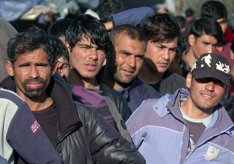 Migrants wait in line to receive supplies from the Red Cross at the Vucijak refugee camp outside Bihac, northwestern Bosnia, Monday, Oct. 21, 2019. Authorities in the town of Bihac on Monday stopped the delivery of water supplies to the Vucjak camp saying they want to draw attention to the problems in the camp set up on a former landfill and near mine fields from the 1992-95 war. (AP Photo/Eldar Emric)