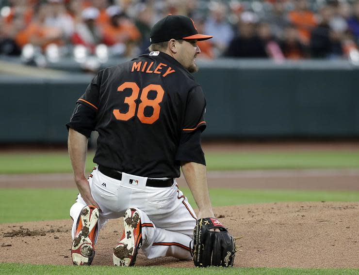 Baltimore Orioles pitcher Wade Miley kneels after being hit by a line drive single by Avisail Garcia of the White Sox. (AP)