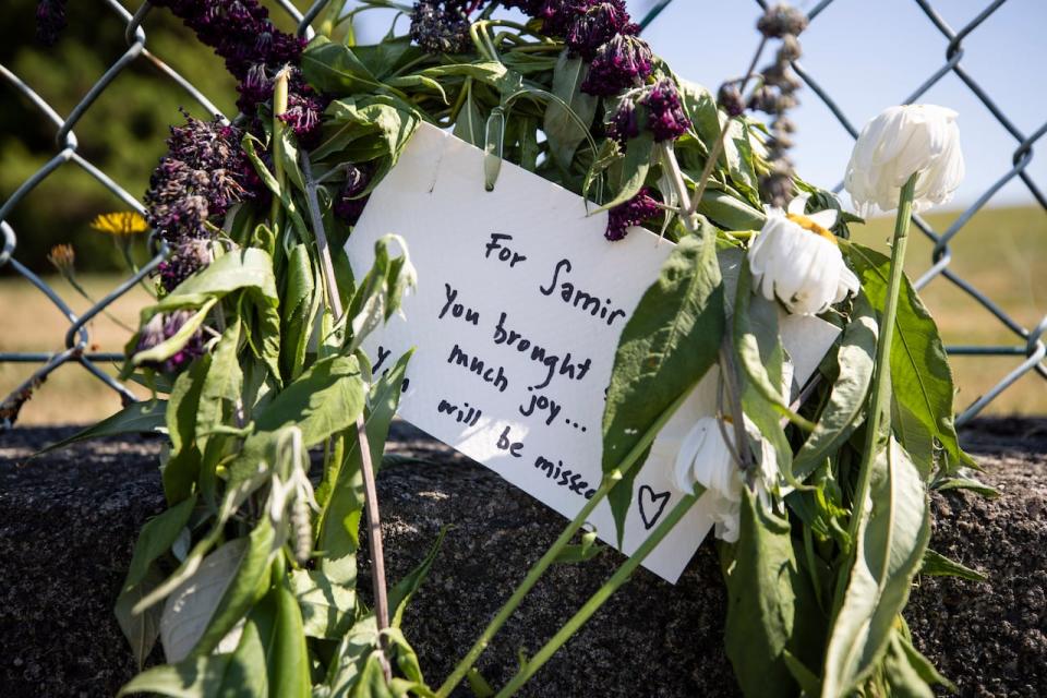 A memorial is pictured near 10th Avenue and Sixth Street after a multi-car crash that left two people dead in New Westminster, British Columbia, on Thursday, July 28, 2022. 