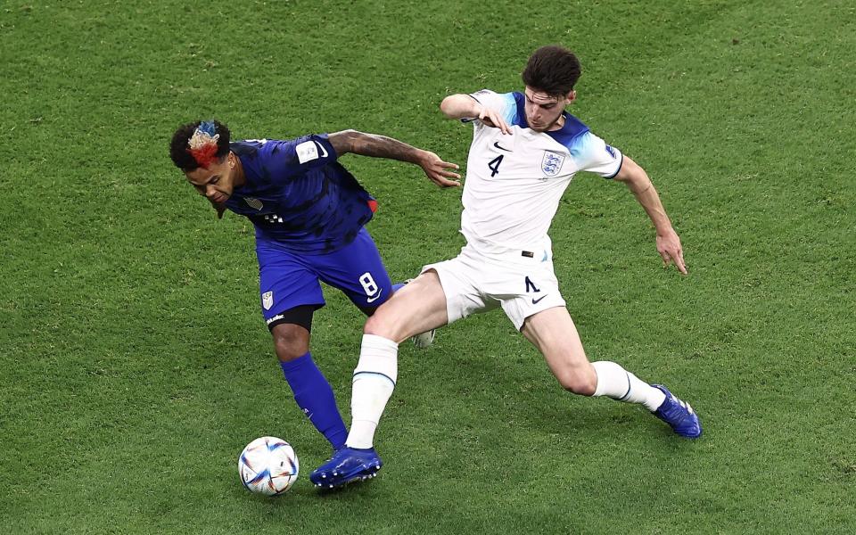 Weston McKennie of United States is challenged by Declan Rice/World Cup 2022 TV schedule: How to watch England and the matches live today - GETTY IMAGES