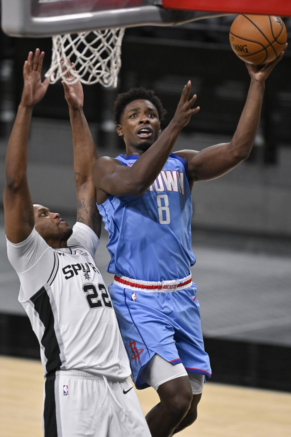 Houston Rockets' Jae'Sean Tate (8) shoots as he is defended by San Antonio Spurs' Rudy Gay during the second half of an NBA basketball game, Saturday, Jan. 16, 2021, in San Antonio. (AP Photo/Darren Abate)