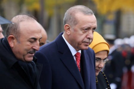 Turkish President Recep Tayyip Erdogan and Turkish Foreign Minister Mevlut Cavusoglu leave a commemoration ceremony for Armistice Day, 100 years after the end of the First World War, at the Arc de Triomphe, in Paris, France, November 11, 2018. Ludovic Marin/Pool via REUTERS