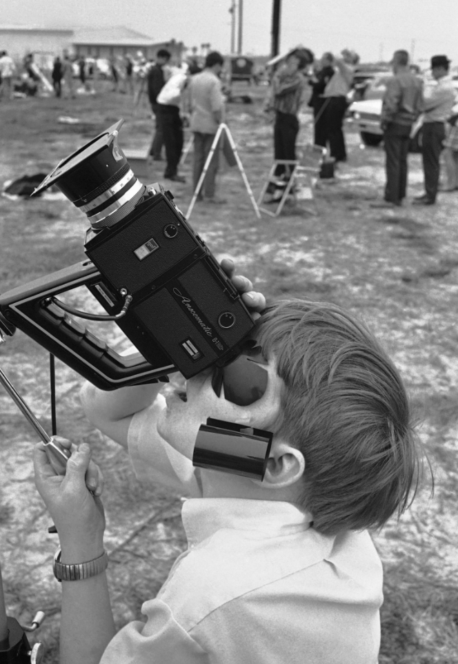 Steve Spalding squints through a viewfinder during a total solar eclipse on March 7, 1970 that was shrouded by clouds.
