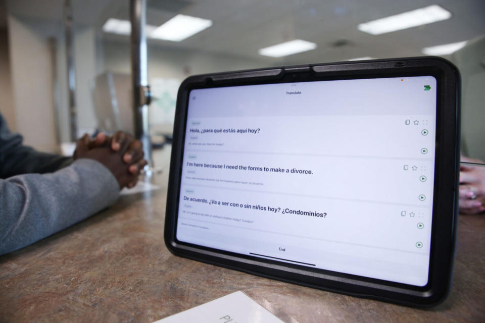 The Minnehaha Clerk of Courts uses a software through Certified Languages International to interpret a conversation between Spanish and English at the Minnehaha Courthouse on April 25, 2024. The device is part of a pilot program to improve language access in the state court system. (Makenzie Huber/South Dakota Searchlight)