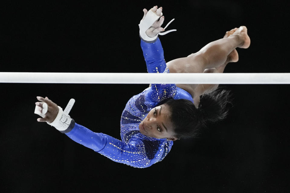FILE - United States' Simone Biles competes on the uneven bars during the women's all-round final at the Artistic Gymnastics World Championships in Antwerp, Belgium, Friday, Oct. 6, 2023. Biles is bringing back her Gold Over America Tour this fall, with a twist. This time, the guys are invited too.(AP Photo/Virginia Mayo, File)