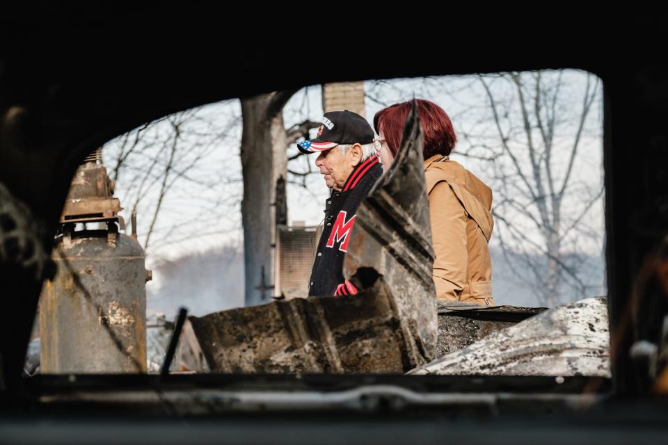 Robert Stratton, left, and his daughter Kathy Jordan, look over the remains of Stratton's business Lincoln and Things on Tuesday in Sherrodsville. A fire Monday afternoon leveled the structure, which held about 8,000 toys for Tuscarawas County Toys for Tots.