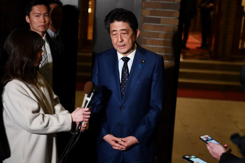 Japan's Prime Minister Shinzo Abe talks to the journalists in front of the prime minister's residence in Tokyo