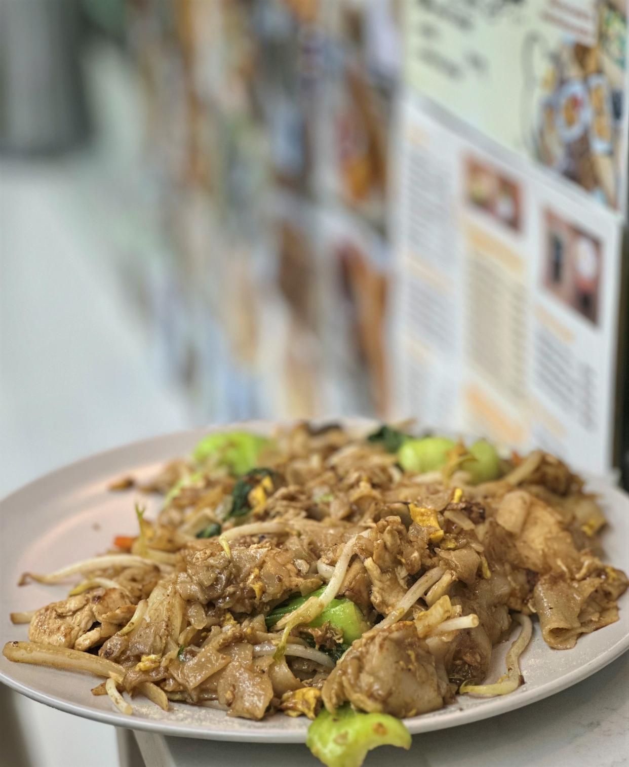 The wok imparts its smoky breath on dishes like char kway teow with chicken.