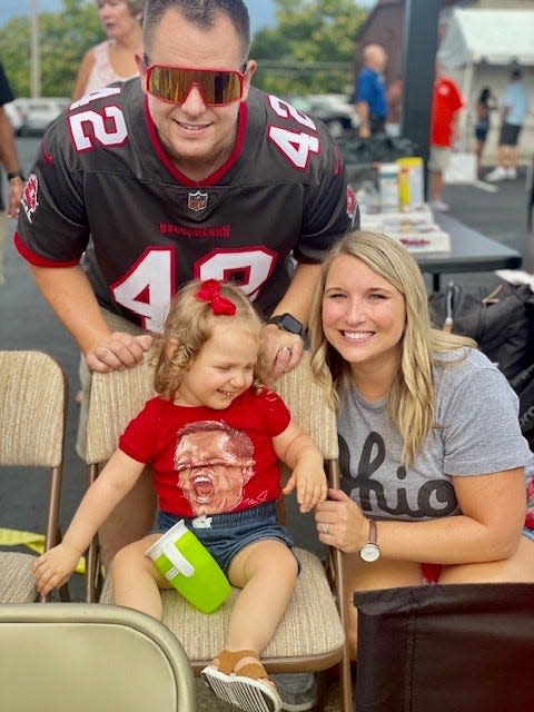 Richie Williams, his wife Kelsey Williams and their daughter Quinn are shown attending the 2022 Pro Football Hall of Fame Enshrinement Festival.