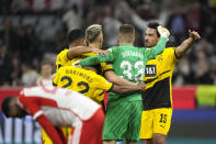 Borussia Dortmund players celebrate their victory at the German Bundesliga soccer match between FC Bayern Munich and Borussia Dortmund at the Allianz Arena stadium, in Munich, Germany, Saturday, March 30, 2024. (AP Photo/Matthias Schrader)