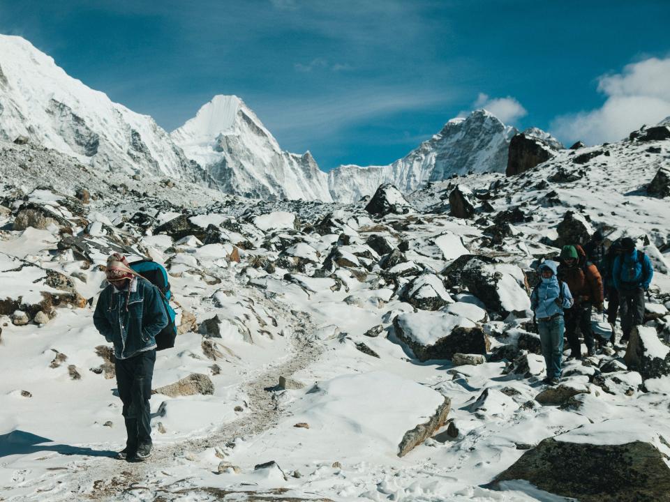 : A line of trekkers walk through fresh snow beside the Khumbu Glacier, near the base of Mount Everest and Everest Base Camp in the Solu-Khumbu region of Nepal, February 13, 2015