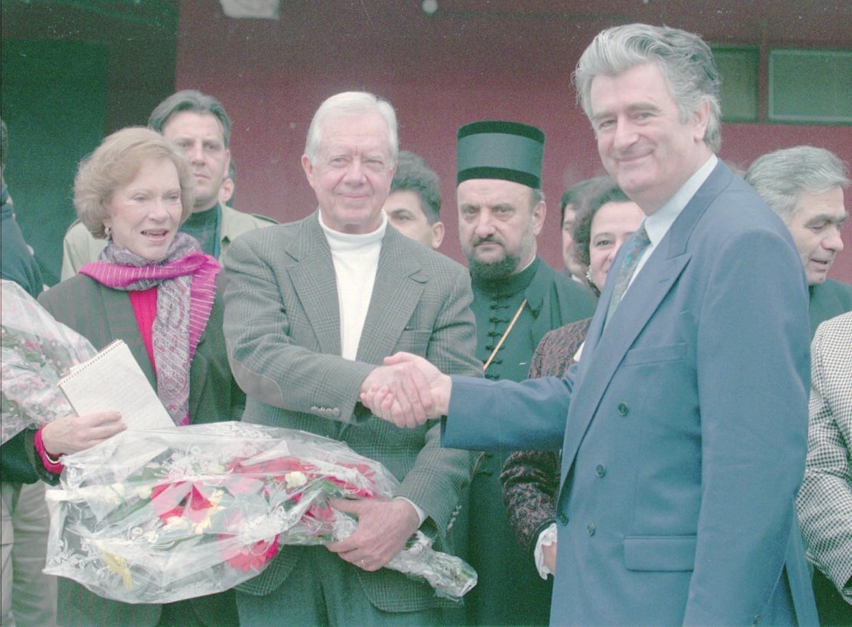 Former President Jimmy Carter, center; accompanied by his wife Rosalyn, left; shakes hands with Bosnian Serb leader Radovan Karadzic, right; before their meeting on Dec. 19, 1994, in the Bosnian Serb stronghold of Pale, Bosnia. After his previous successful missions in North Korea and Haiti, former President Carter came to Pale to try to break a deadlock in Bosnia's peace talks.