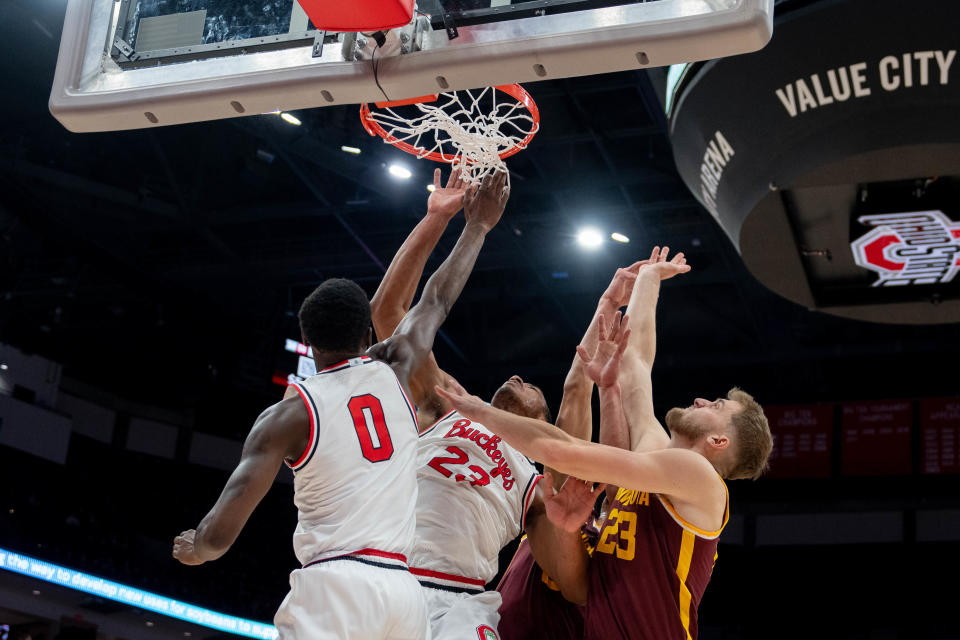 Ohio State guard Scotty Middleton (0) and forward Zed Key battle Minnesota players for a rebound on Dec. 3.