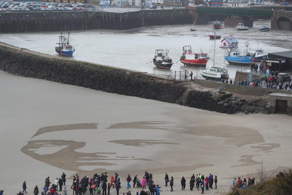 <p>A beach drawing of war poet Wilfred Owen during the Pages of the Sea commemorative event at Folkestone (Steve Parsons/PA) </p>