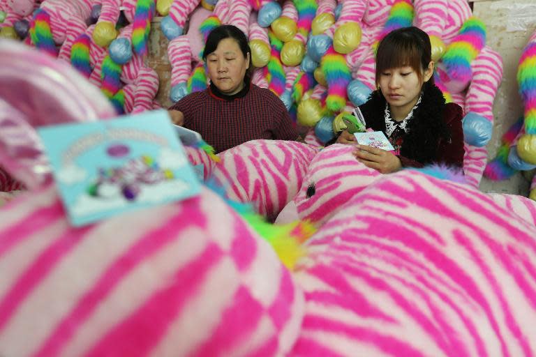 Workers check toys produced at a factory in Lianyungang, east China's Jiangsu province, on April 14, 2015