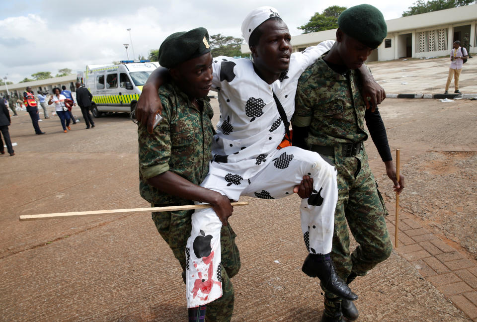 <p>Policemen carry an injured man after police fired tear gas to try to control a crowd of people trying to force their way into a stadium to attend the inauguration of Kenyaâs President Uhuru Kenyatta at Kasarani Stadium in Nairobi, Kenya, Nov. 28, 2017. (Photo: Baz Ratner/Reuters) </p>