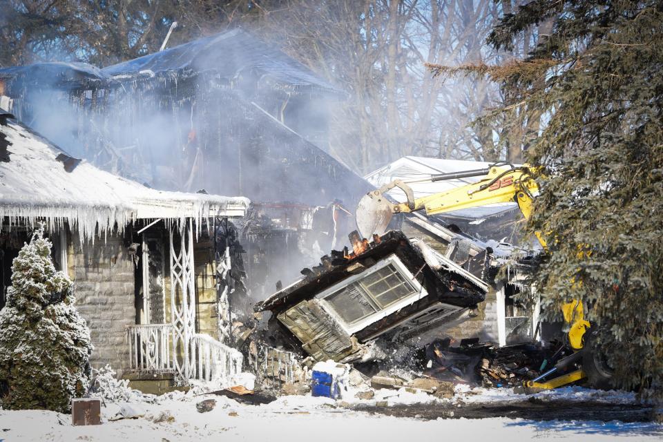 A section of the home located at 1715 N. James Street is taken down by an excavator after a fatal house fire Saturday, Jan. 15, 2022 in Rome. Crews had to contend with negative temperatures and wind chill in addition to the blaze.