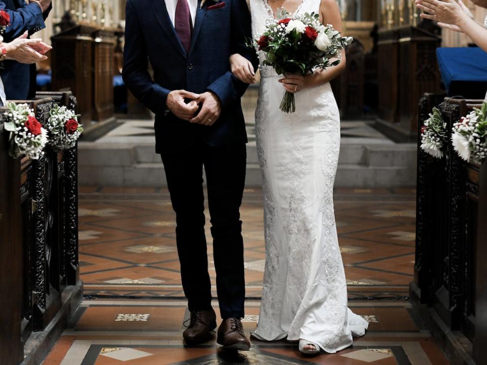 couple walking down the aisle at their wedding in a church