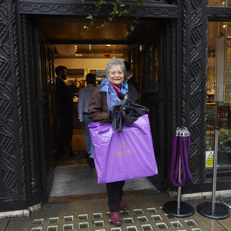 One of the first customers exists the store with the calendar. [Photo: Liberty London] 