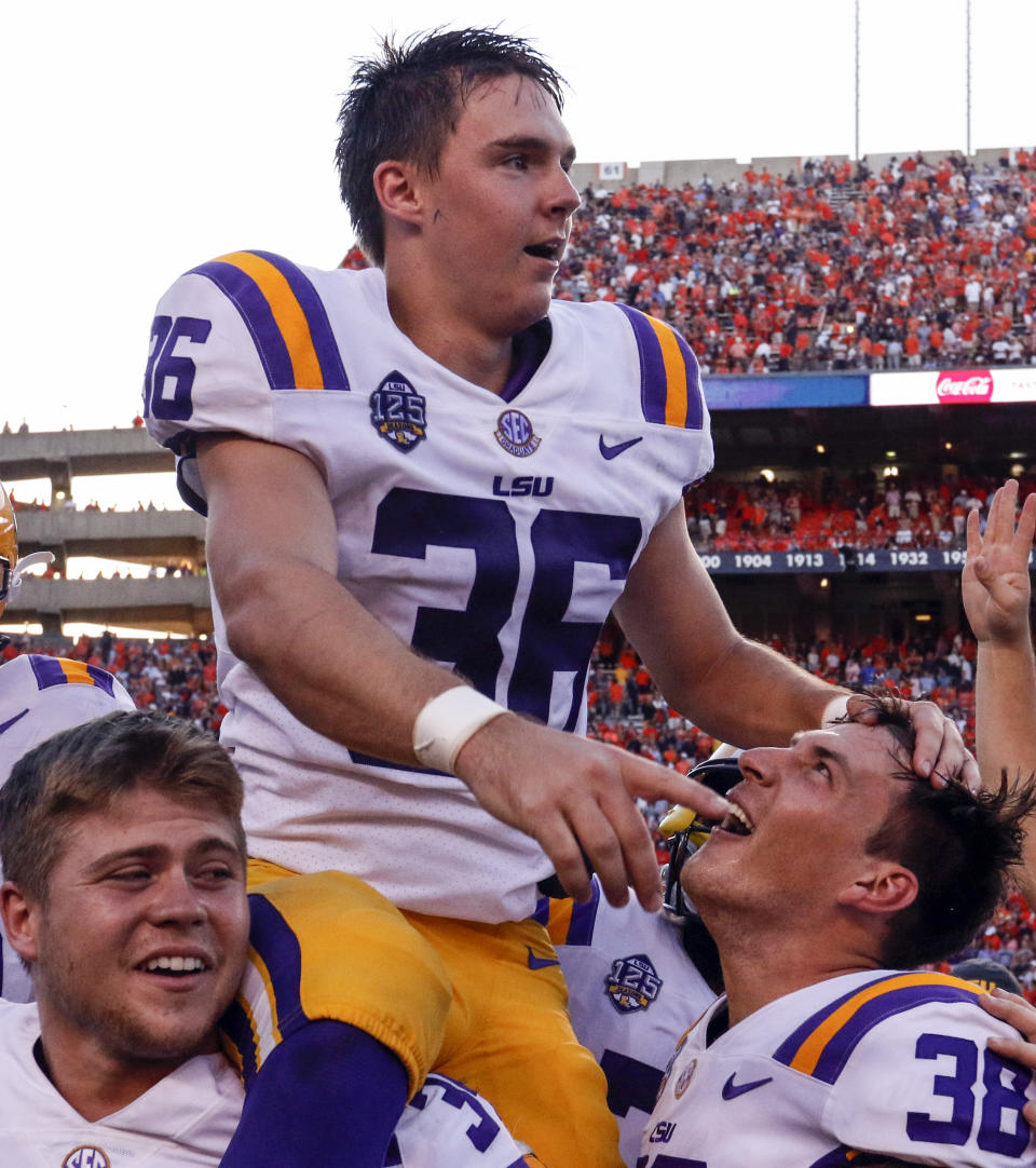 LSU place kicker Cole Tracy (36) is hoisted on the shoulders of his teammates after kicking the winning field goal to defeat Auburn 22-21 during the second half of an NCAA college football game, Saturday, Sept. 15, 2018, in Auburn, Ala. (AP Photo/Butch Dill)