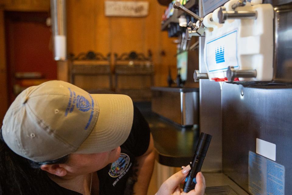 Joanie Garza, a public health inspector with the city, checks an ice cream machine nozzle for cleanliness during a restaurant inspection June 6, 2023, in Corpus Christi, Texas.