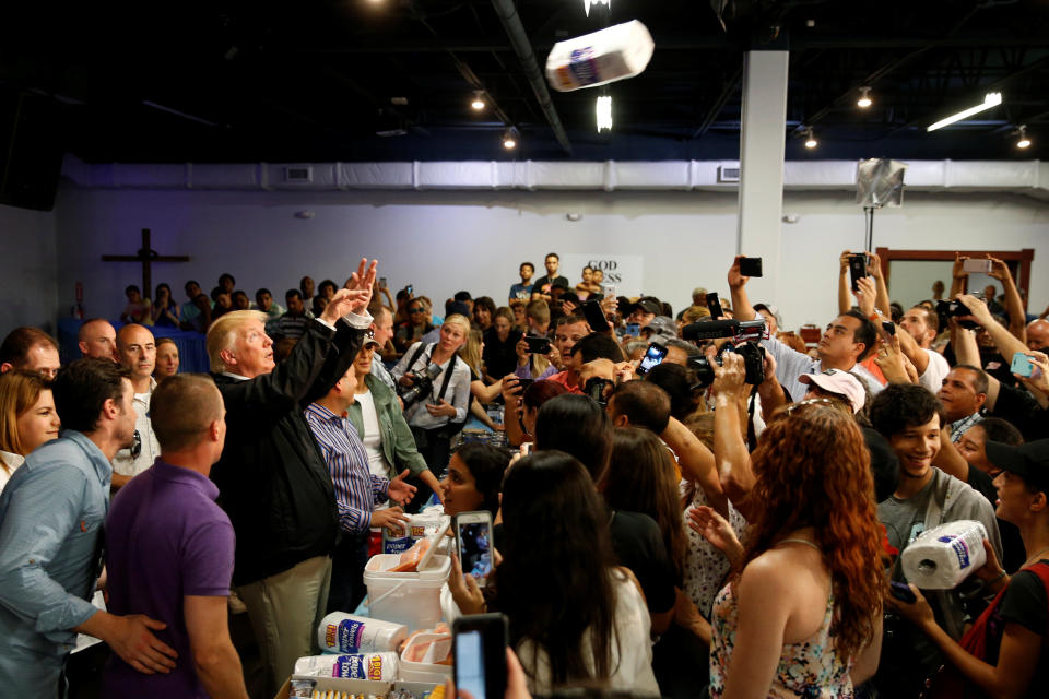 President Donald Trump tosses rolls of paper towels to people at a hurricane relief distribution center in San Juan on Oct. 3, 2017. (Jonathan Ernst / Reuters)