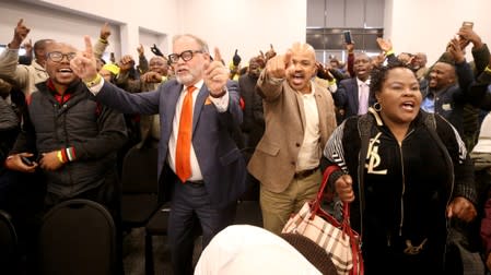 Supporters of former South African President Jacob Zuma sing and dance during a break in proceedings at the Commission of Inquiry into State Capture in Johannesburg