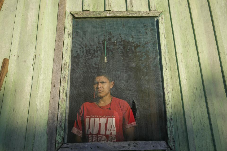 Pure Juma, son of Borea Juma, stand inside his house at the Juma Indigenous community, near Canutama, Amazonas state, Brazil, Sunday, July 9, 2023. "I kind of broke the anthropology rules and followed my mother's lineage," he said. "If I don't identify myself as Juma, who else will?" (AP Photo/Andre Penner)