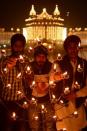 Indian Sikh devotees light oil lamps at the Golden Temple in Amritsar on November 13, 2012, on the ocassion of Bandi Chhor Divas or Diwali. Sikhs celebrate Bandi Chhor Divas or Diwali to mark the return of the Sixth Guru, Guru Hargobind Ji, who was freed from imprisonment and also managed to release 52 political prisoners at the same time from Gwalior fort by Mughal Emperor Jahangir in 1619. Photo: Narinder Nanu, AFP/Getty Images / SF