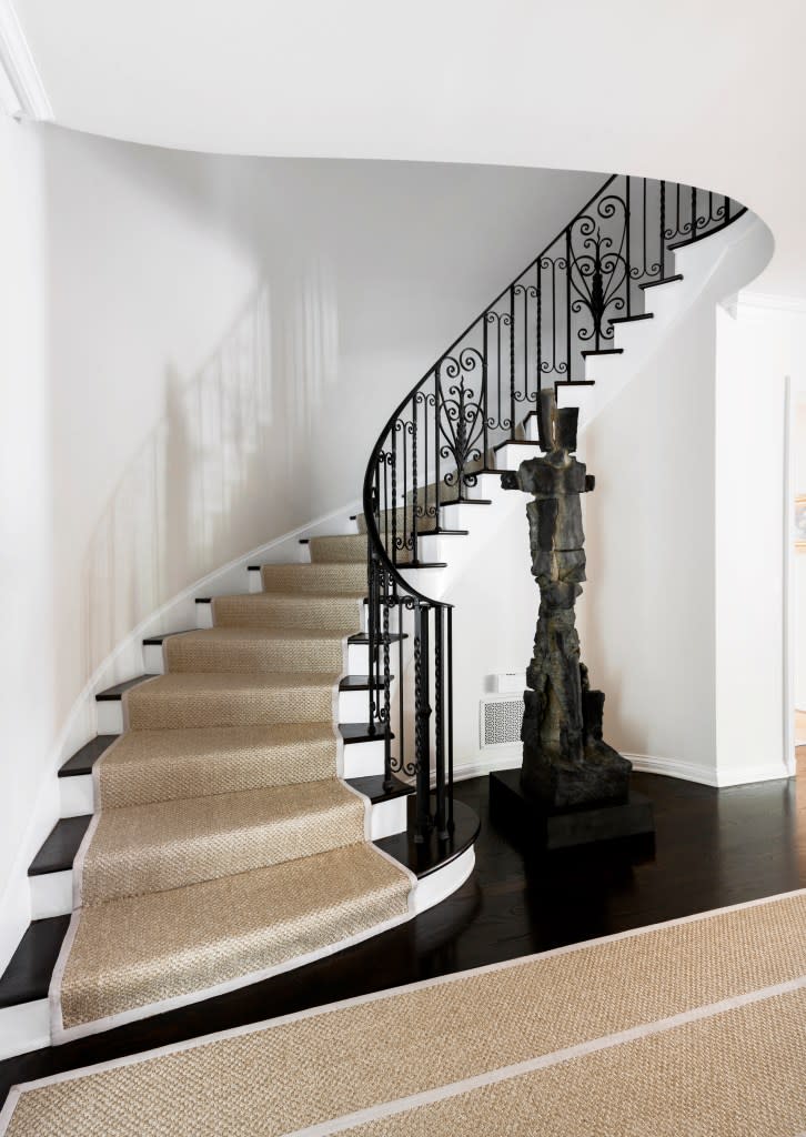 A wrought-iron banister anchors the entry. Paul Barnaby