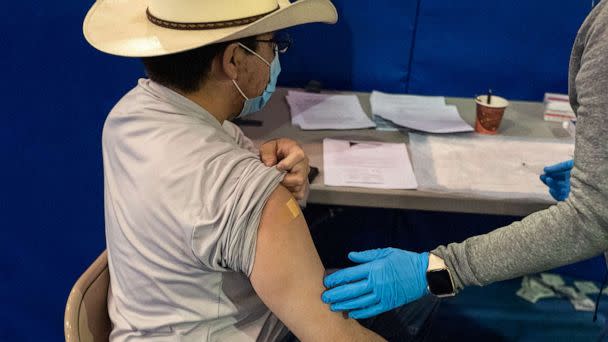 PHOTO: A healthcare worker speaks with a person that received a second dose of the Pfizer-BioNTech COVID-19 vaccine at the University of New Mexico's Gallup campus in Gallup, N.M., March 23, 2021. (Cate Dingley/Bloomberg via Getty Images)