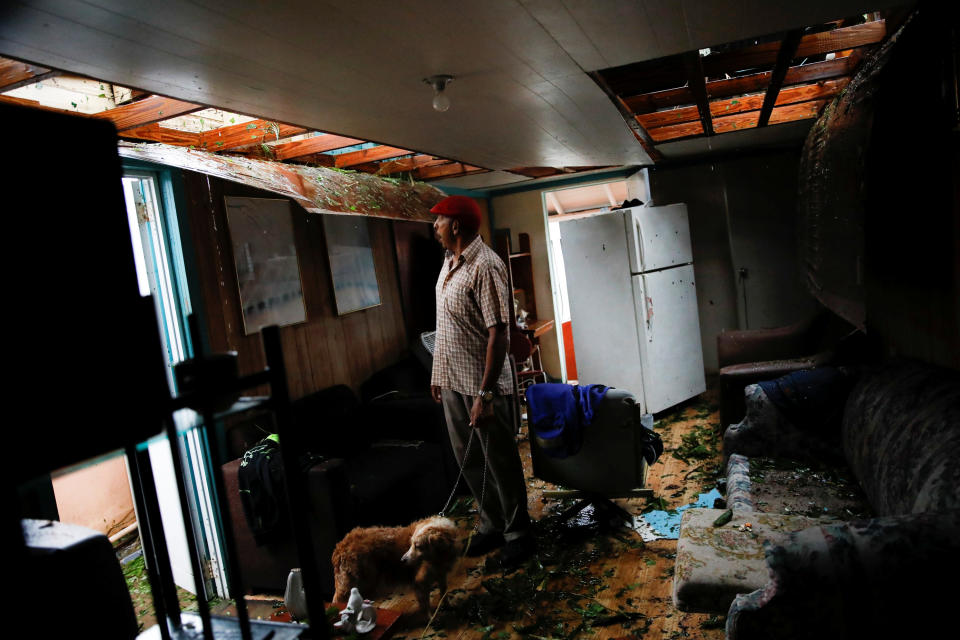 <p>Agapito Lopez looks at the damage in his house after the area was hit by Hurricane Maria in Guayama, Puerto Rico, Sept. 20, 2017. (Photo: Carlos Garcia Rawlins/Reuters) </p>