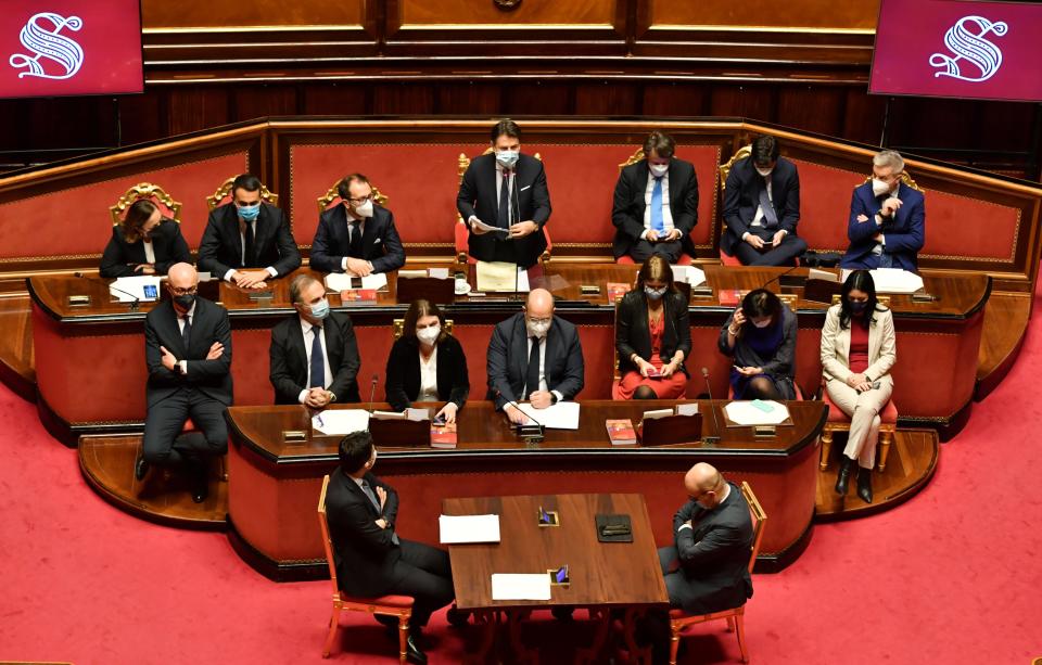 Premier Giuseppe Conte, top center, delivers his speech at the Senate, in Rome, Tuesday, Jan. 19, 2021. Conte fights for his political life with an address aimed at shoring up support for his government, which has come under fire from former Premier Matteo Renzi's tiny but key Italia Viva (Italy Alive) party over plans to relaunch the pandemic-ravaged economy. (Andreas Solaro/Pool via AP)